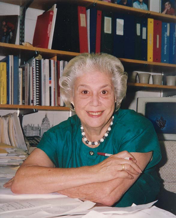 woman sitting at desk | obituary