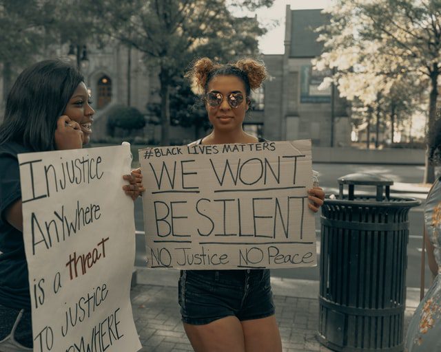 Two women holding Black Lives Matter signs