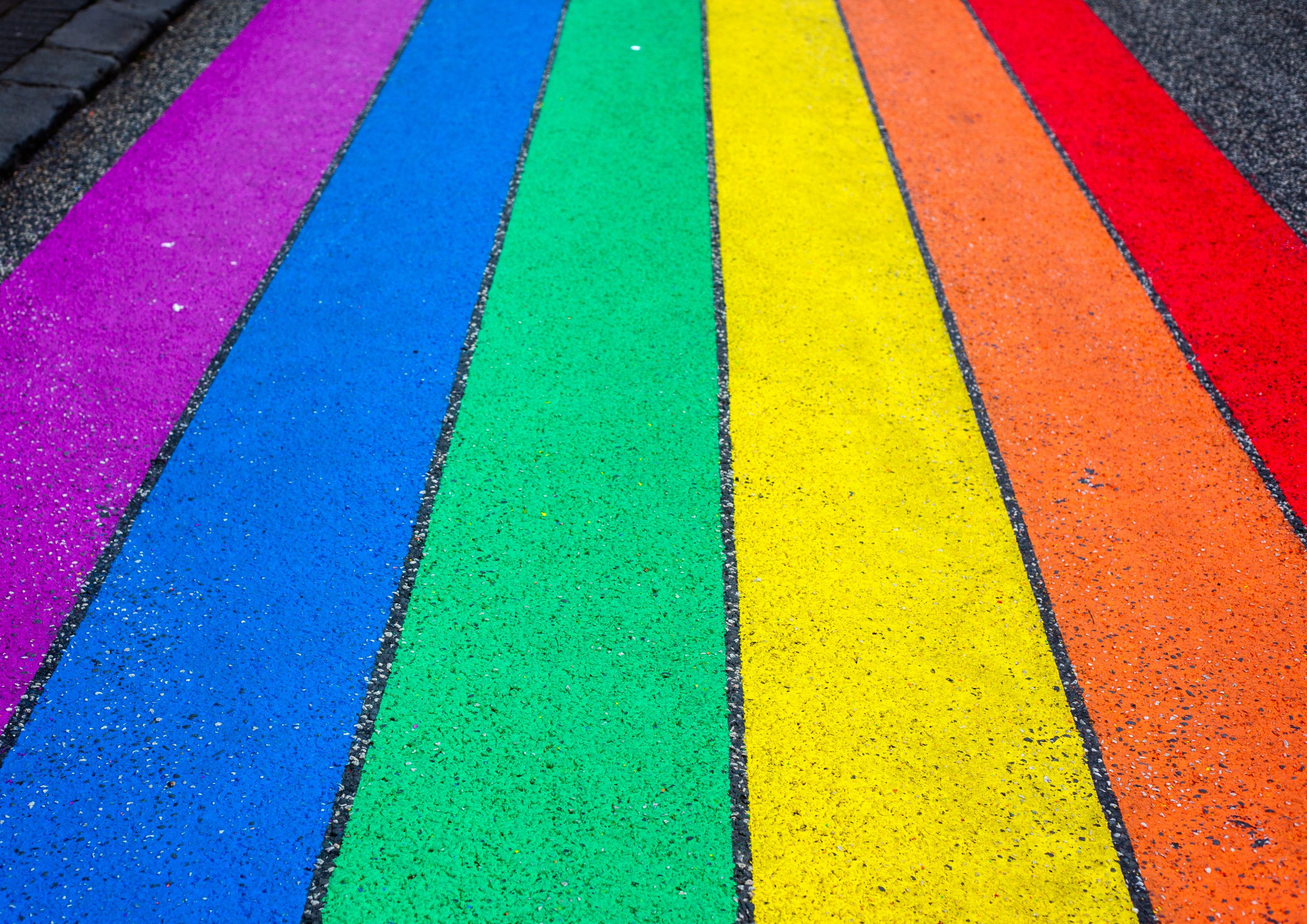 Photograph of rainbow stripes painted on asphalt