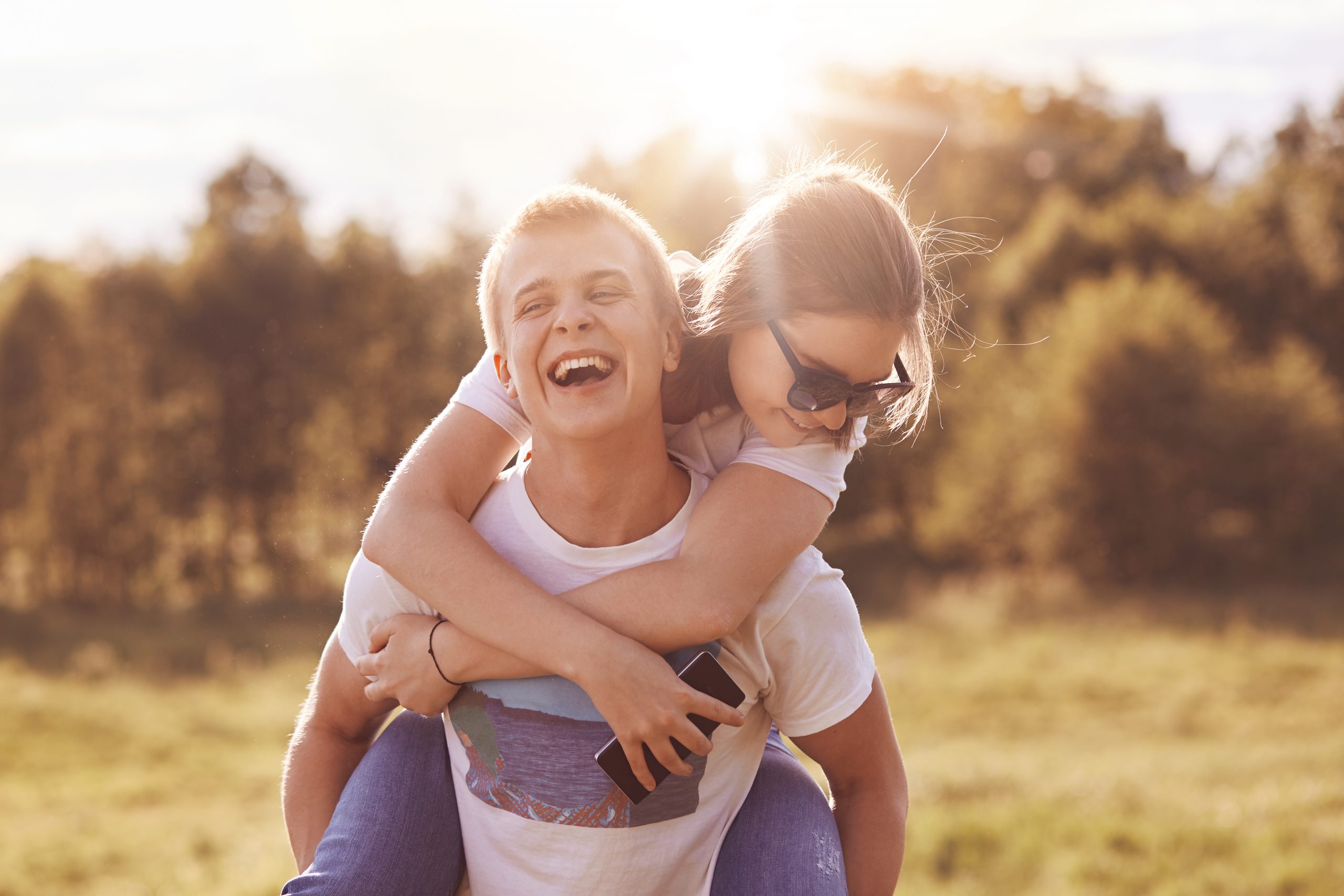 boy gives piggyback to his girlfriend