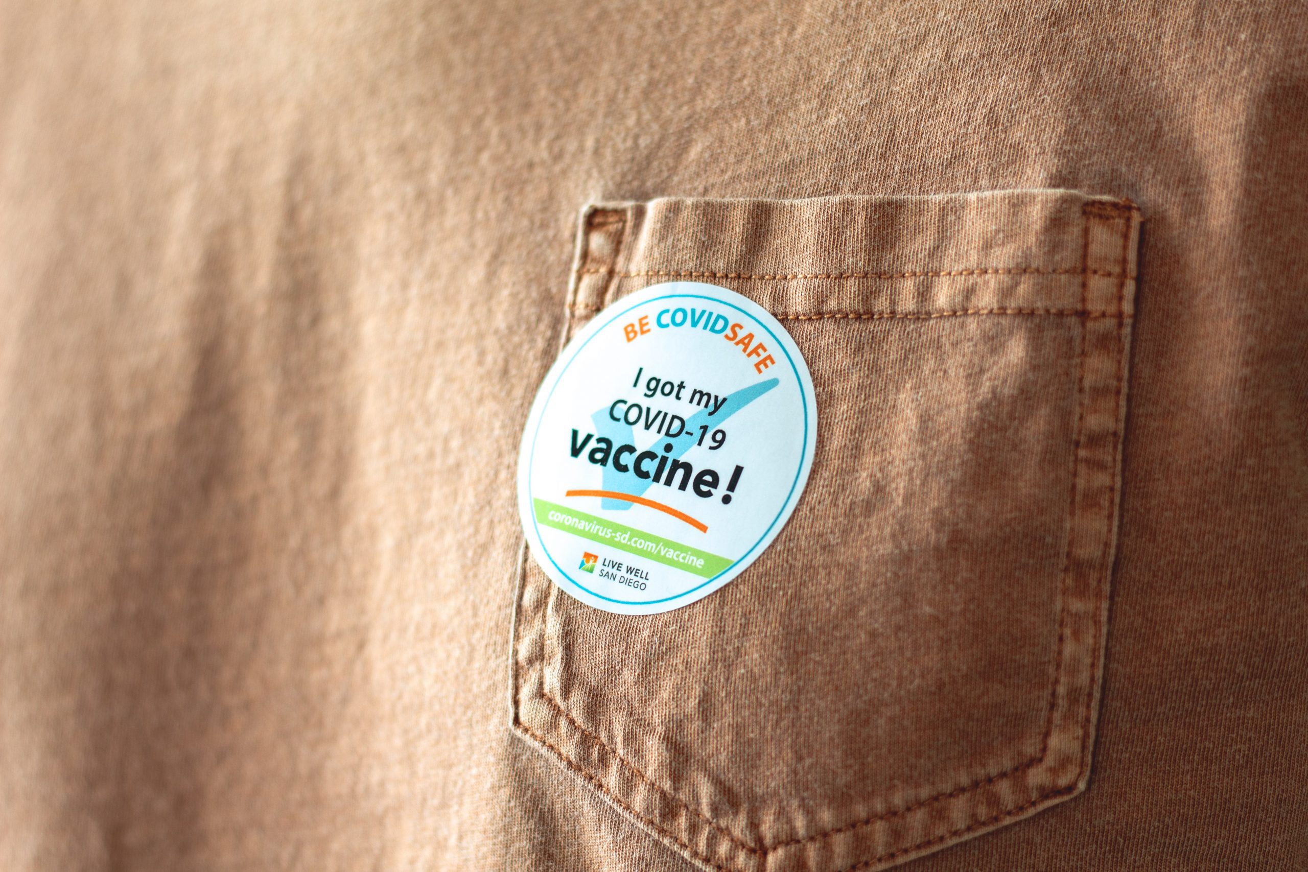 Photograph of pocket on brown fabric with a sticker stating "I got my COVID-19 vaccine!"