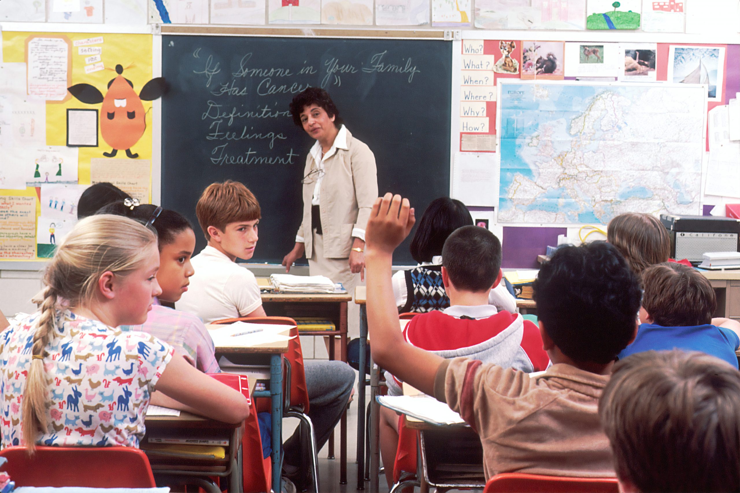 woman standing in front of children in a classroom