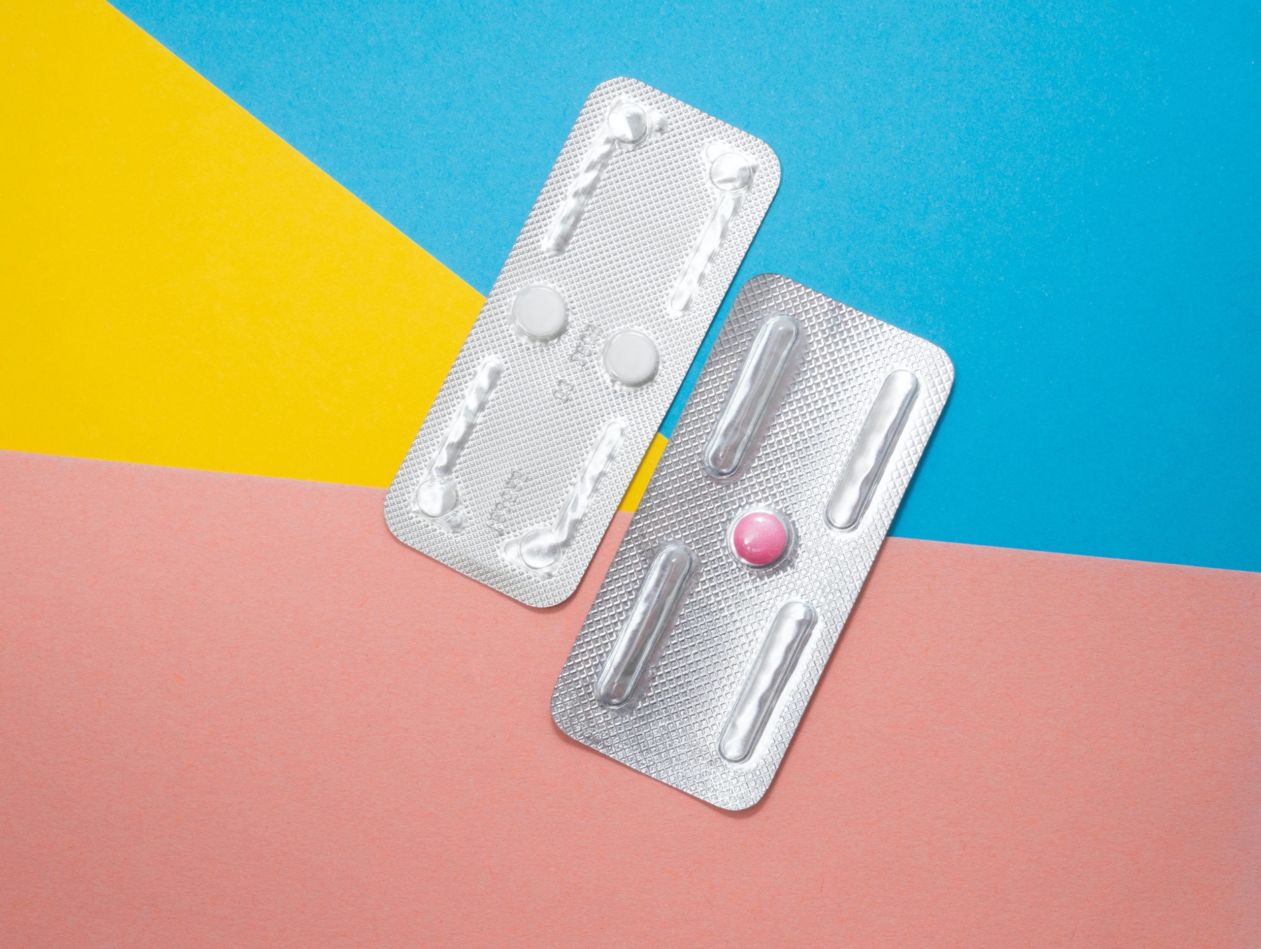image of emergency contraception pill in wrapper on a geometric background